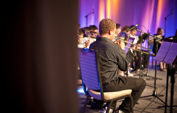 student playing instrument in band