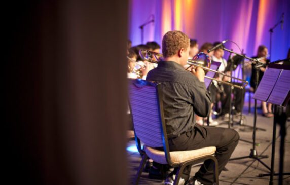 student playing instrument in band