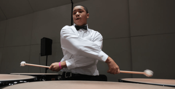 Student playing the timpani