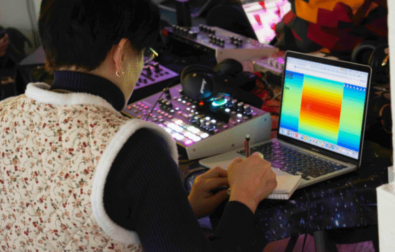 Teacher working on music technology and creativity with resources