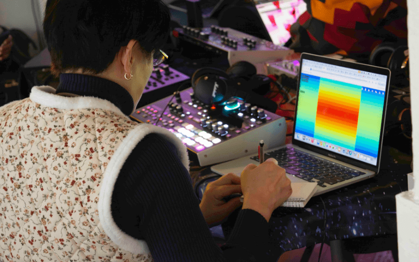 Teacher working on music technology and creativity with resources