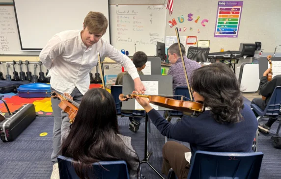 String students working with their teacher