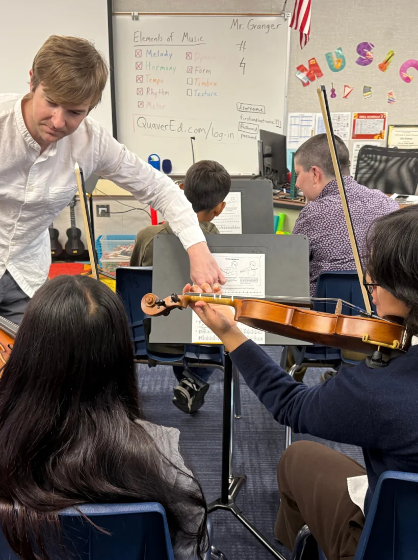 String students working with their teacher